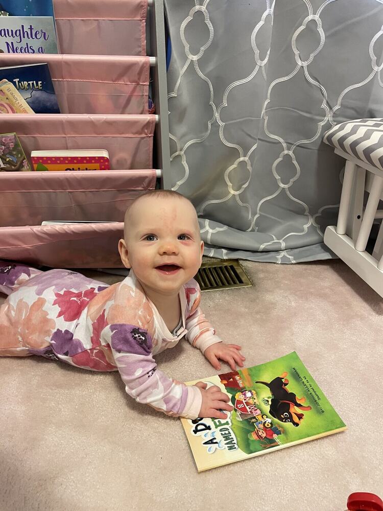 A smiling young reader enjoying A Dog Named Frog
